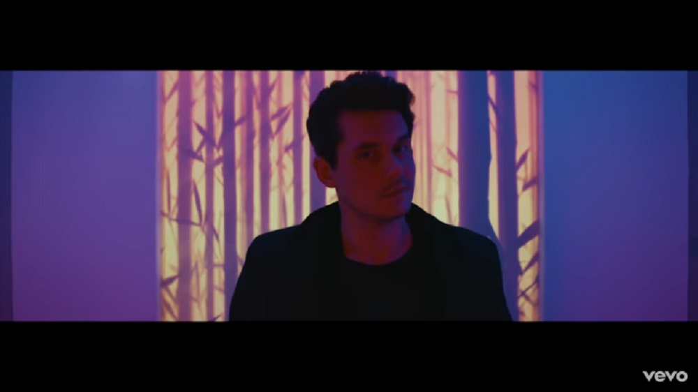 John gets ready to deliver some moves in his new colorful video.